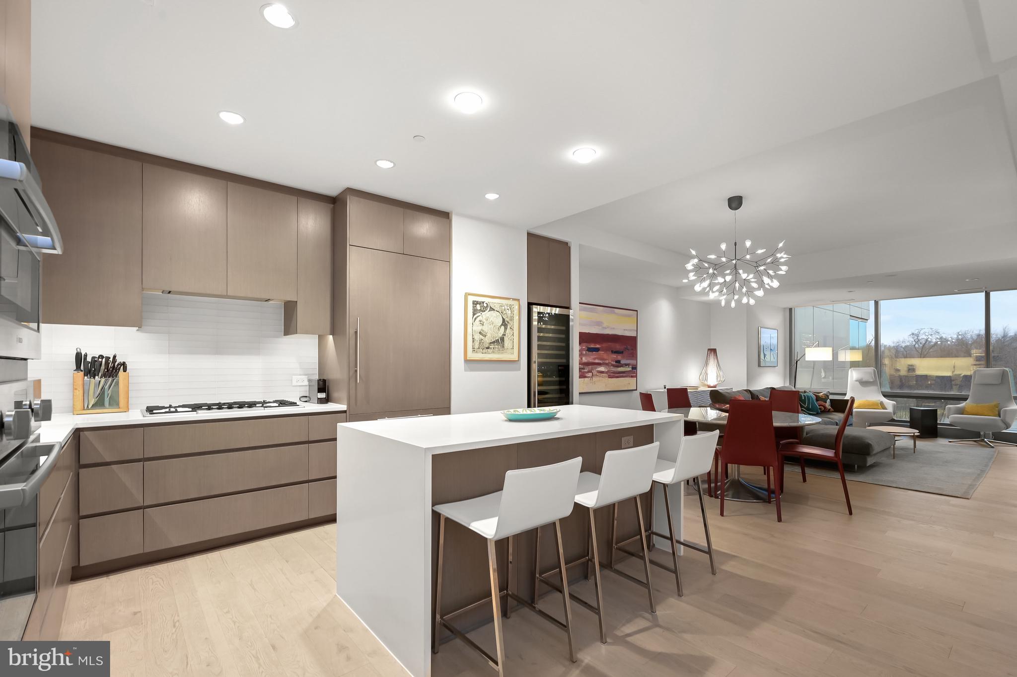 a large kitchen with a table and chairs