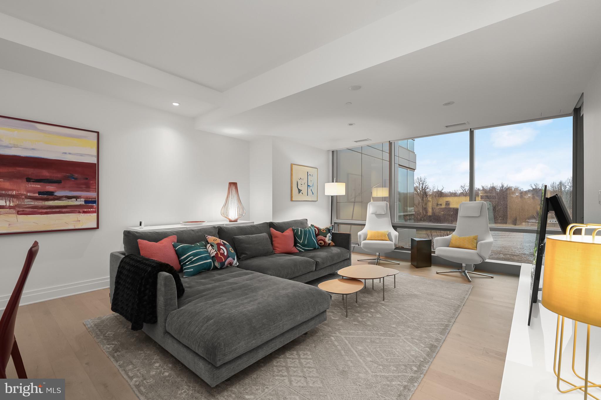 2501 M Street Northwest, Unit 311 Washington, DC 20037 - Photo 3 of 27 a living room with furniture and a large window