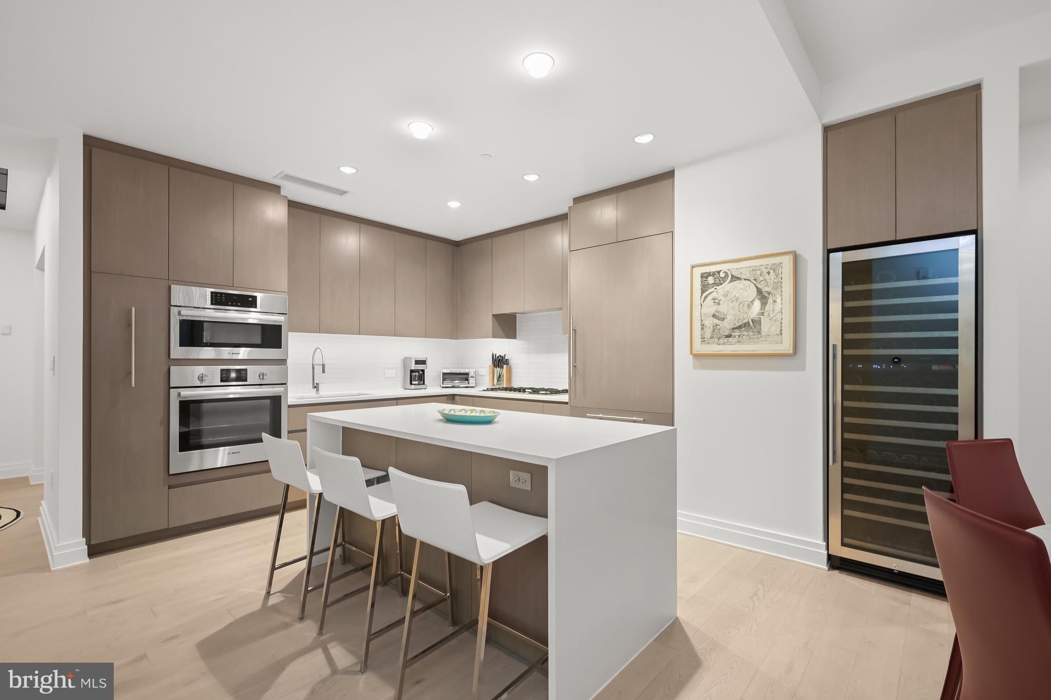 2501 M Street Northwest, Unit 311 Washington, DC 20037 - Photo 6 of 27 a kitchen with stainless steel appliances kitchen island granite countertop a refrigerator and a stove top oven