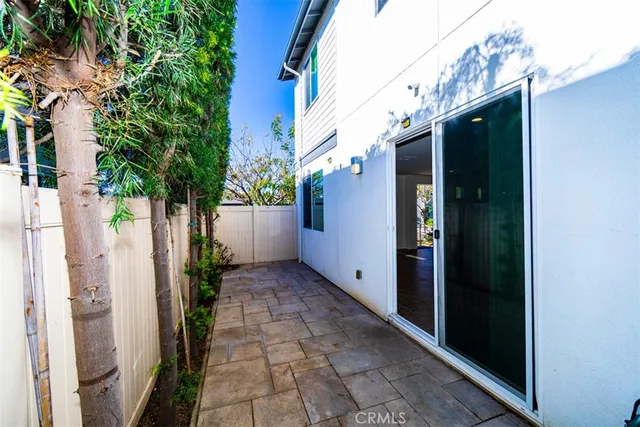 a backyard of a house with potted plants