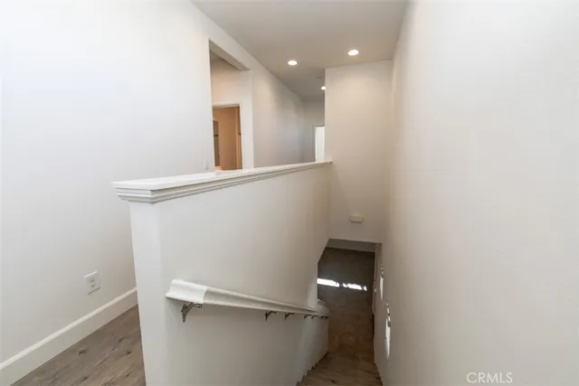 a spacious bedroom with a large bed a chandelier and closet