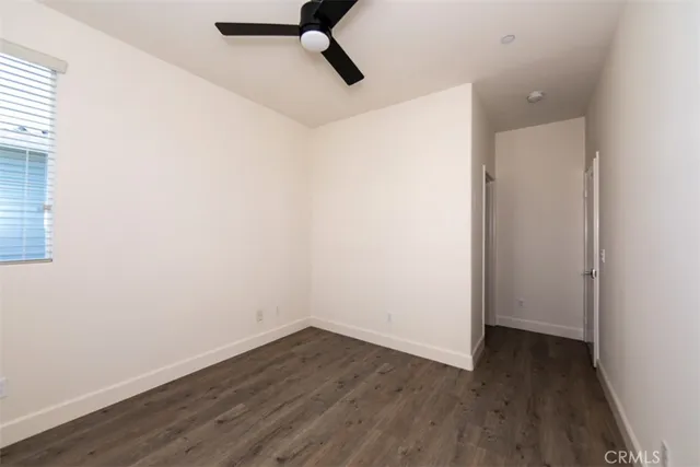a view of hallway with windows and a chandelier