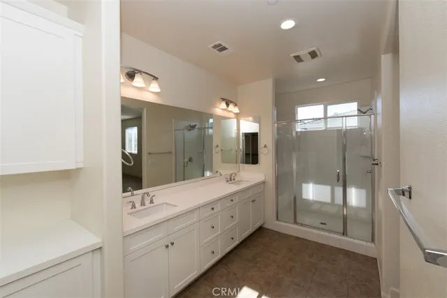 a bathroom with a granite countertop sink mirror and shower