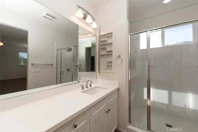 a bathroom with a sink double vanity and a mirror