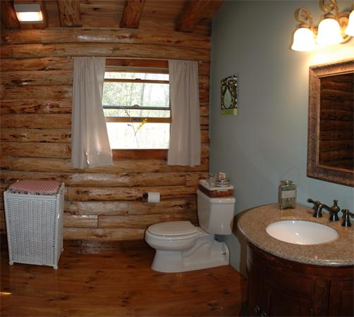 84 Searle Road Huntington, MA 01050 - Photo 16 of 28 a bathroom with a granite countertop toilet a sink and a window