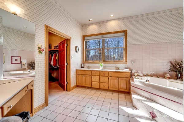 a large white kitchen with a stove a sink dishwasher and a refrigerator