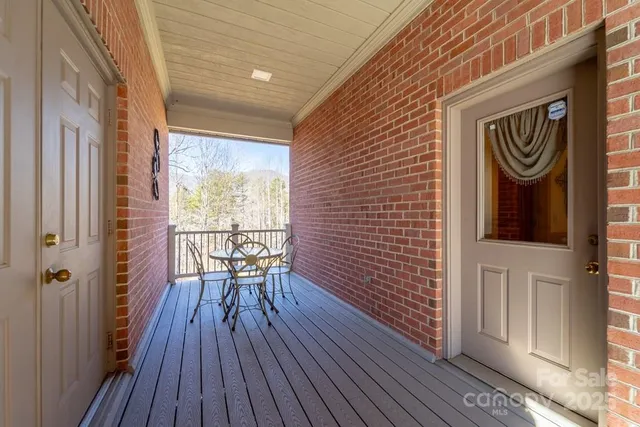 a view of roof deck with wooden floor and fence