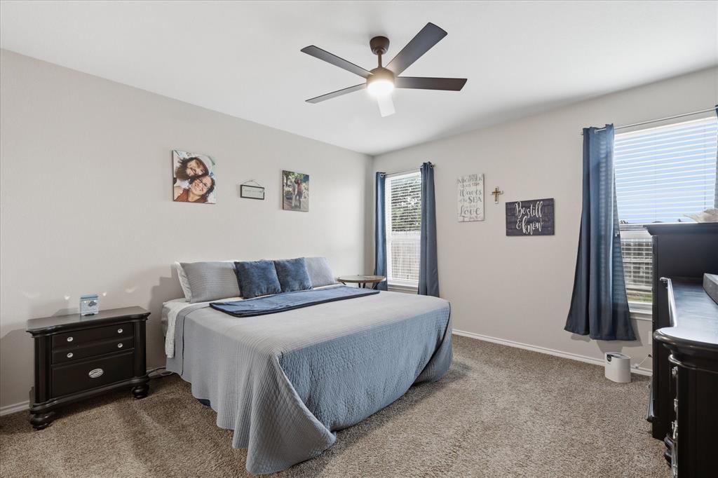 11500 Starlight Ranch Fort Worth, TX 76052 - Photo 19 of 40 This bedroom features carpeting, light-toned walls, and a ceiling fan