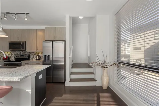 a kitchen with a refrigerator and a sink