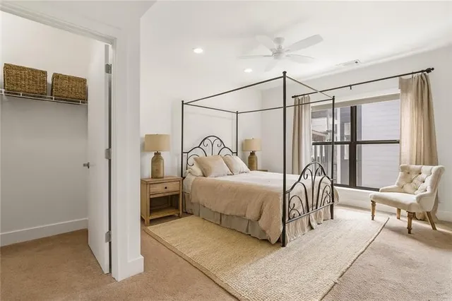 a bedroom with a bed a couch and a window