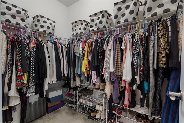 a view of walk in closet with clothes