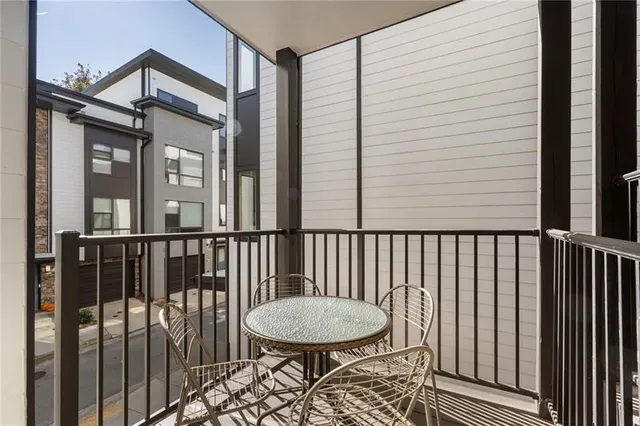 a view of a balcony with a couple of chairs