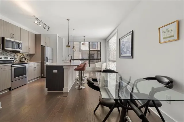 a view of a dining room with furniture and a kitchen