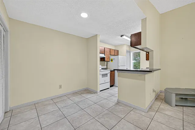 a view of kitchen with microwave and cabinets