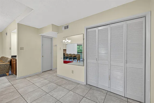 a living room with furniture a chandelier and a window