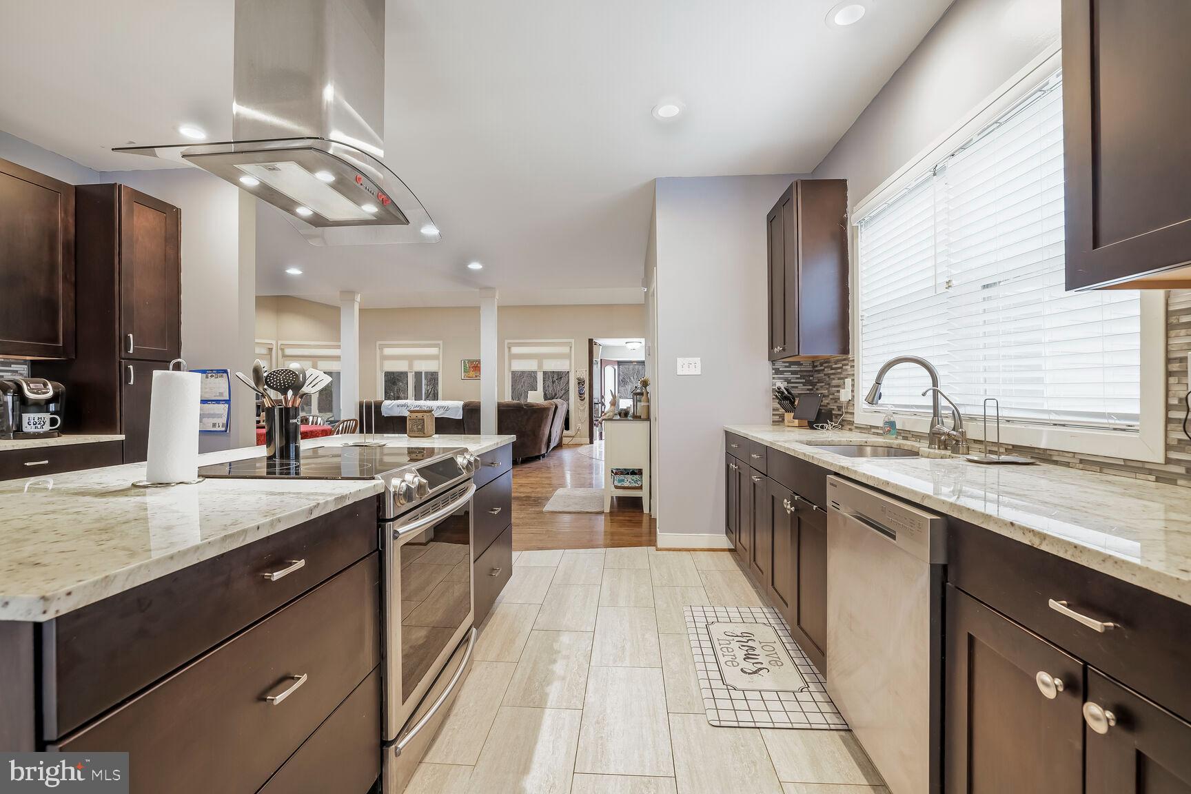 6231 Woodville Road Mount Airy, MD 21771 - Photo 11 of 29 a large kitchen with a large counter top appliances and cabinets