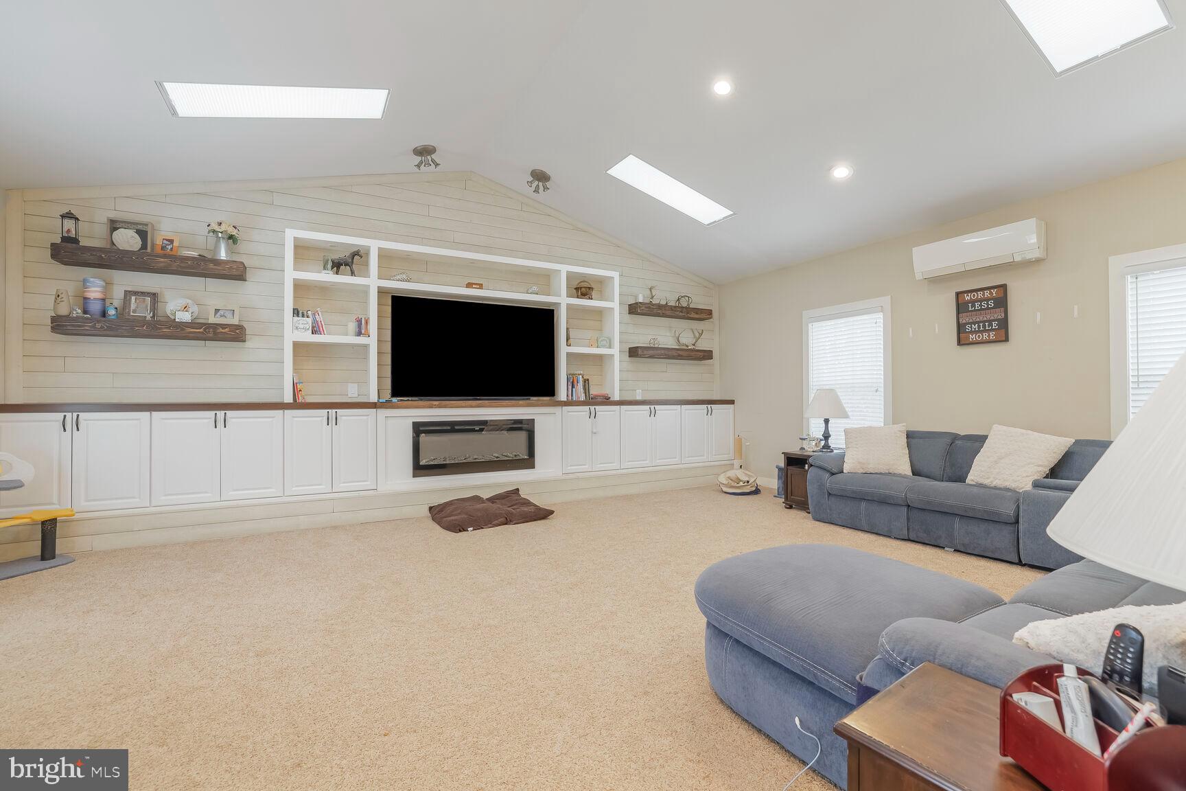 6231 Woodville Road Mount Airy, MD 21771 - Photo 12 of 29 a living room with furniture and a flat screen tv