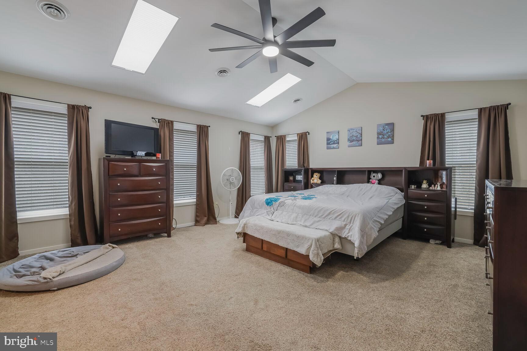 6231 Woodville Road Mount Airy, MD 21771 - Photo 14 of 29 a spacious bedroom with a bed and a dresser