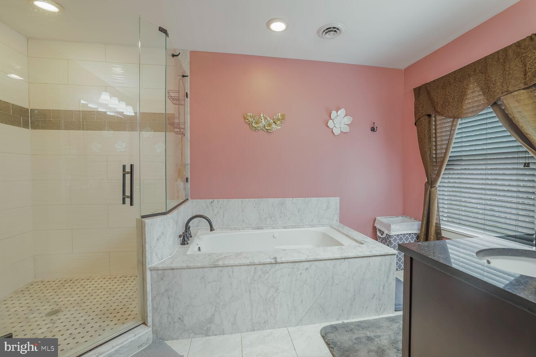 6231 Woodville Road Mount Airy, MD 21771 - Photo 16 of 29 a bathroom with a bathtub and shower