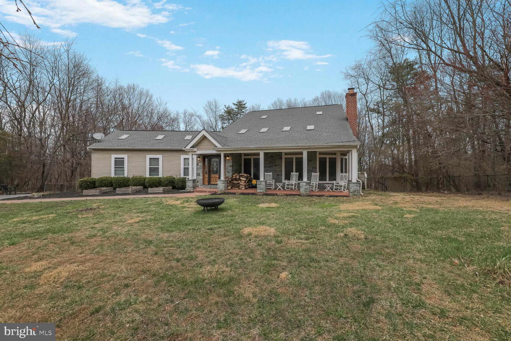 6231 Woodville Road Mount Airy, MD 21771 - Photo 2 of 29 a front view of a house with a garden