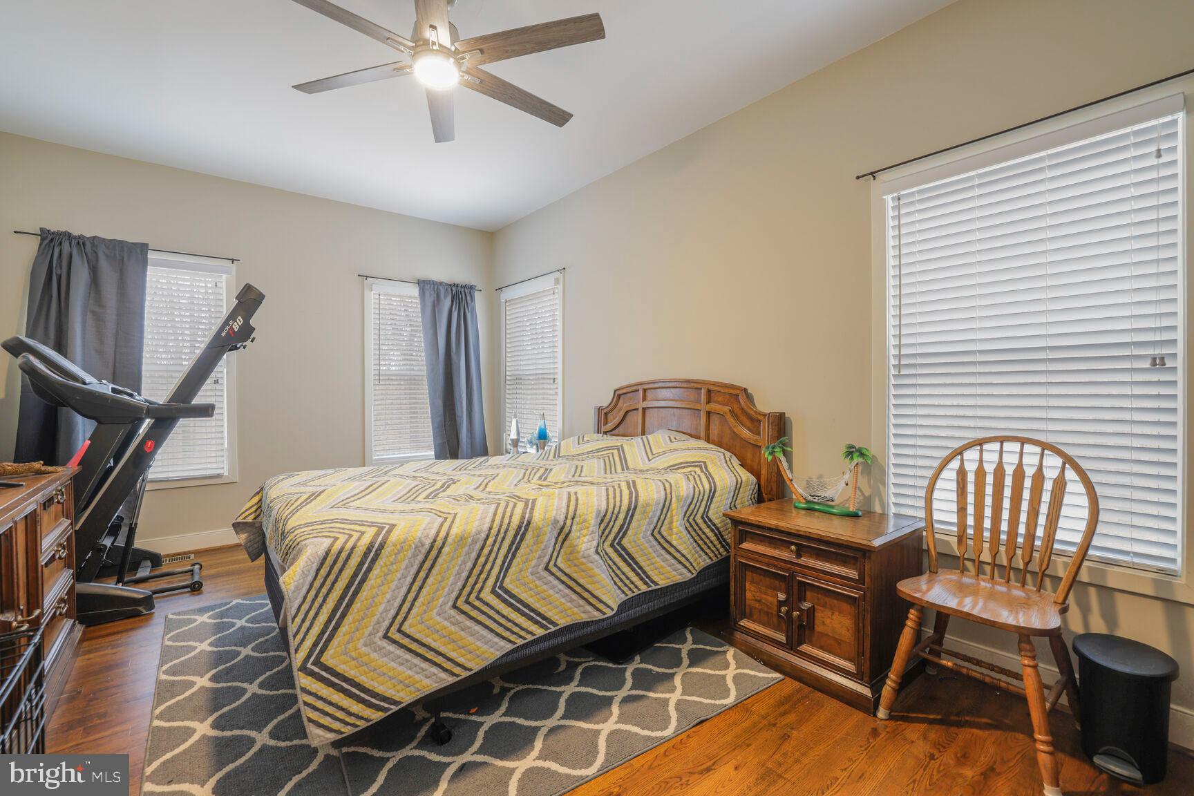 6231 Woodville Road Mount Airy, MD 21771 - Photo 21 of 29 a bedroom with a bed and a chandelier