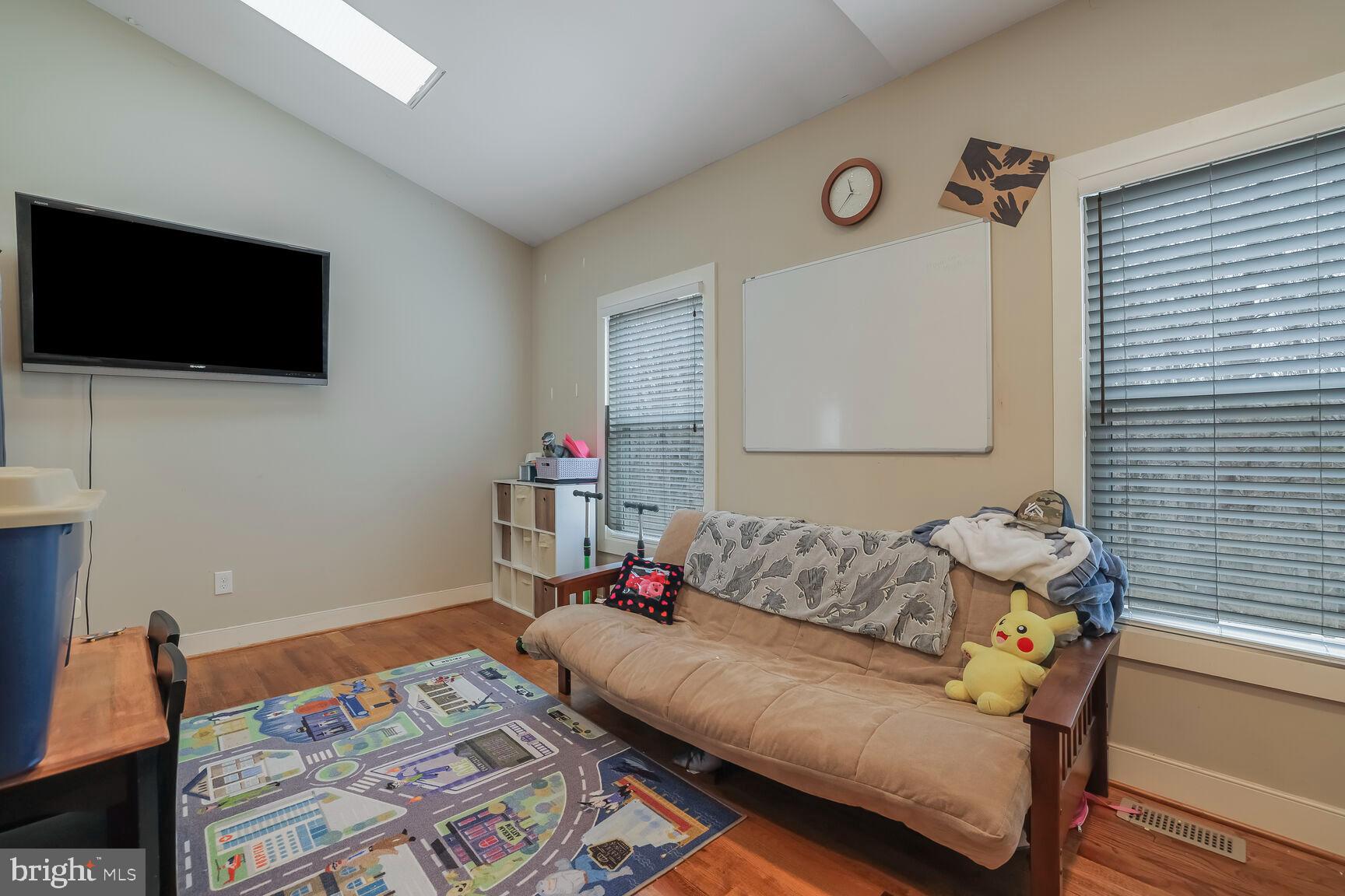 6231 Woodville Road Mount Airy, MD 21771 - Photo 23 of 29 a living room with furniture and a flat screen tv