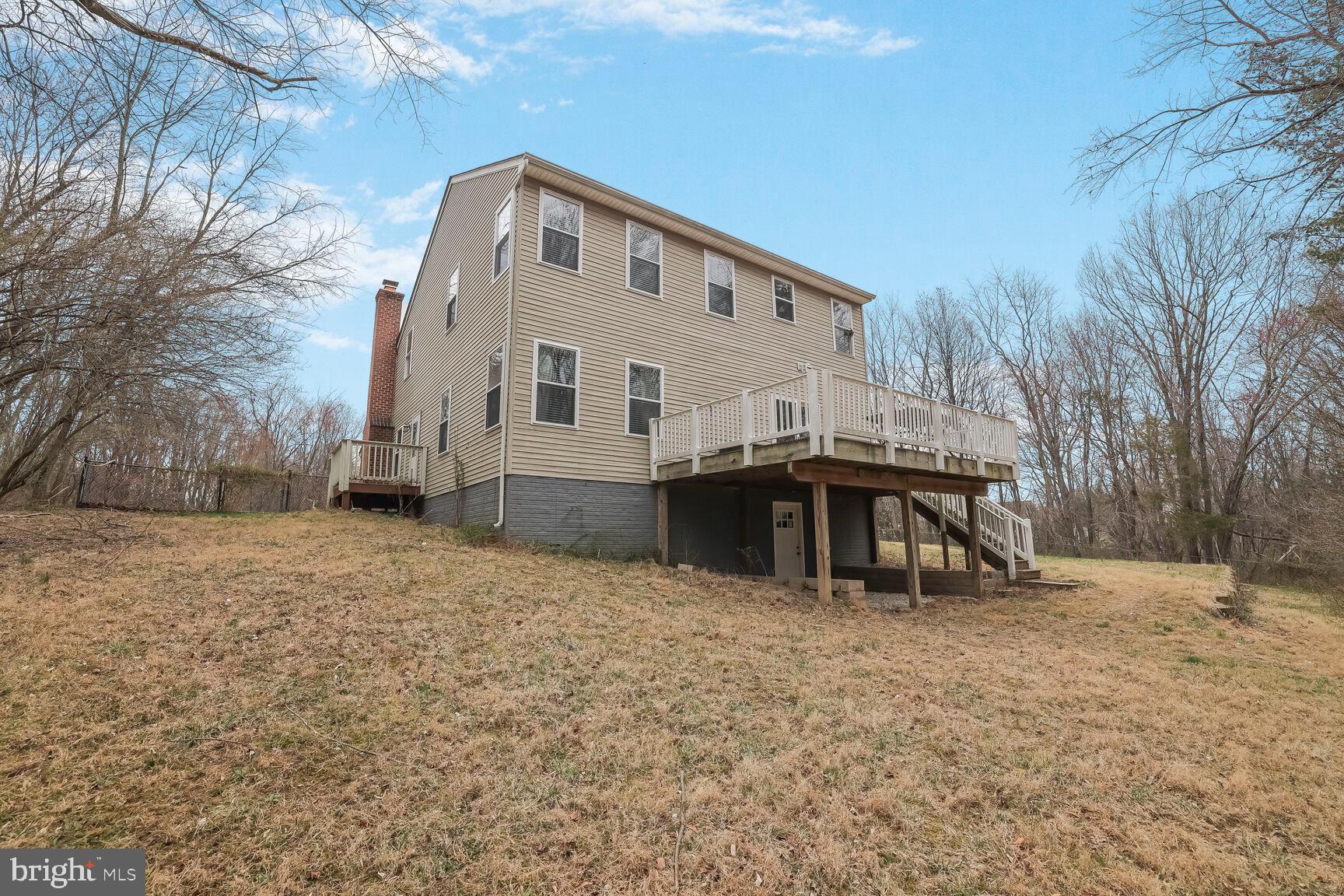 6231 Woodville Road Mount Airy, MD 21771 - Photo 28 of 29 a front view of a house with large trees