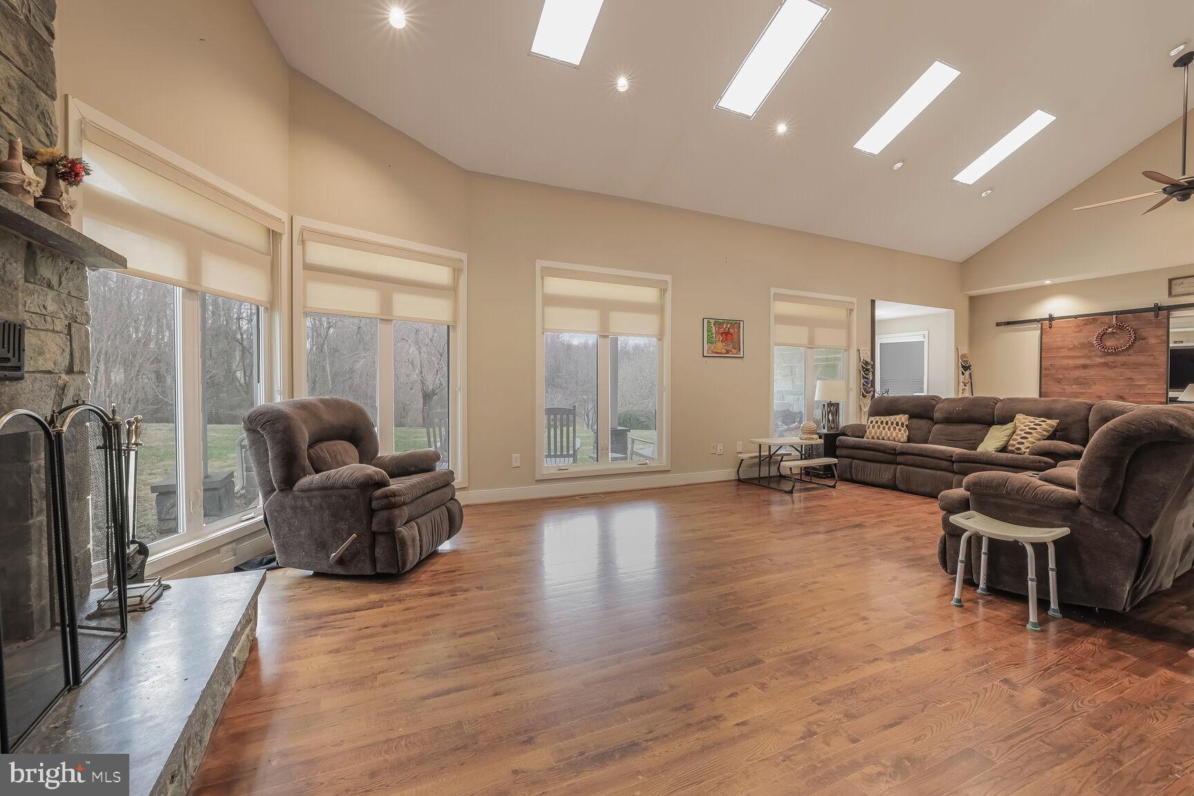 6231 Woodville Road Mount Airy, MD 21771 - Photo 6 of 29 a living room with furniture and a wooden floor