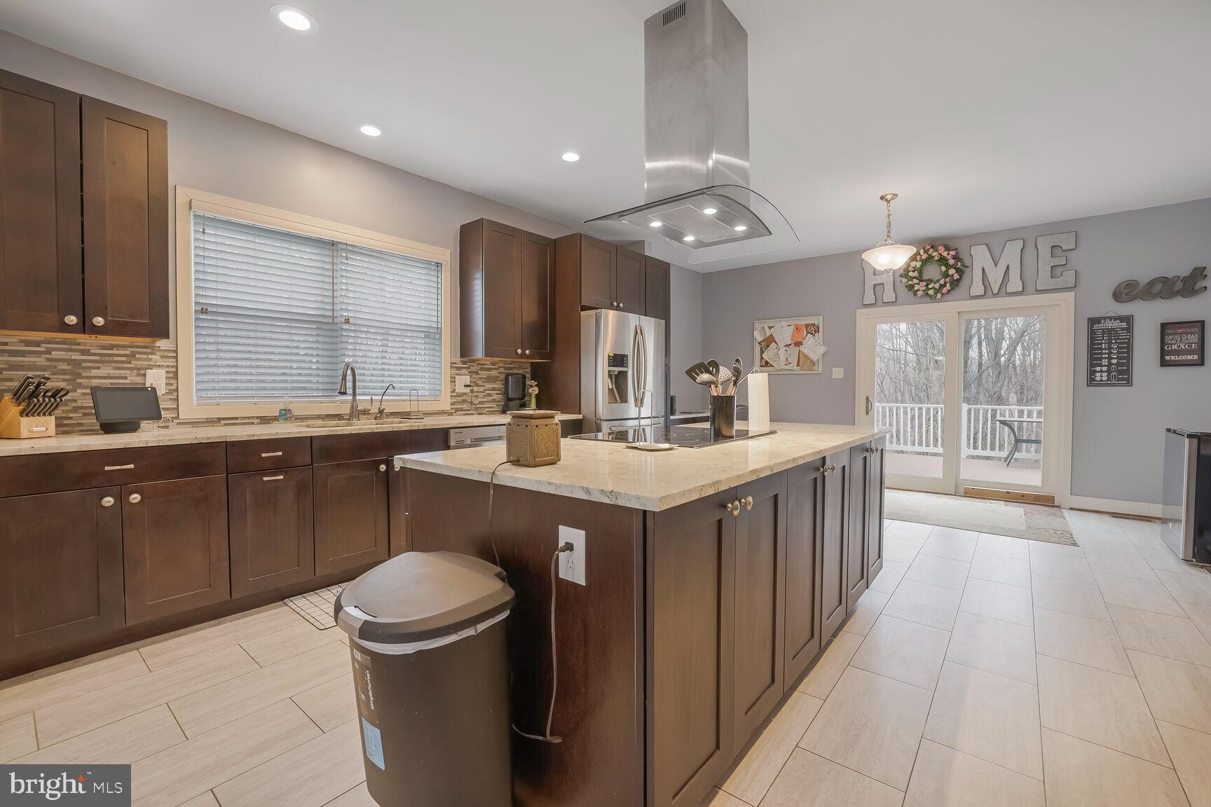 6231 Woodville Road Mount Airy, MD 21771 - Photo 9 of 29 a kitchen with a sink stove and cabinets
