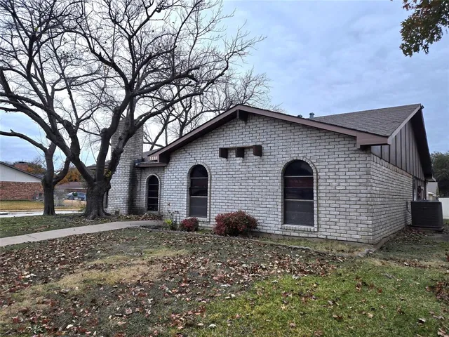a house that has a tree in front of it