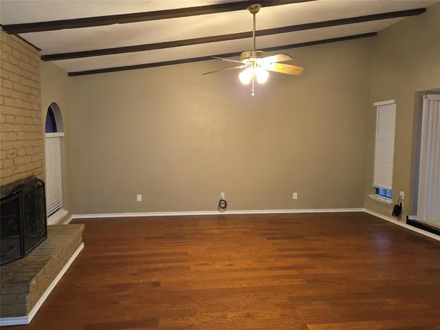 a view of a room with wooden floor and chandelier