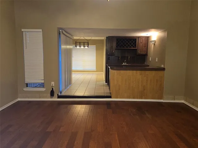 a view of a room with wooden floor and a window