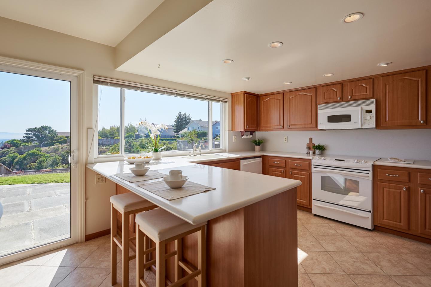 2516 Sherborne Drive Belmont, CA 94002 - Photo 12 of 25 a kitchen with a stove a sink and a refrigerator