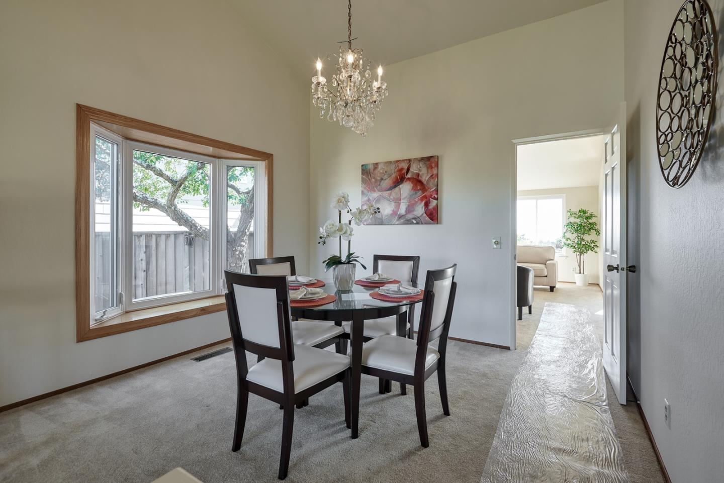2516 Sherborne Drive Belmont, CA 94002 - Photo 8 of 25 a dining room with furniture a painting and a chandelier