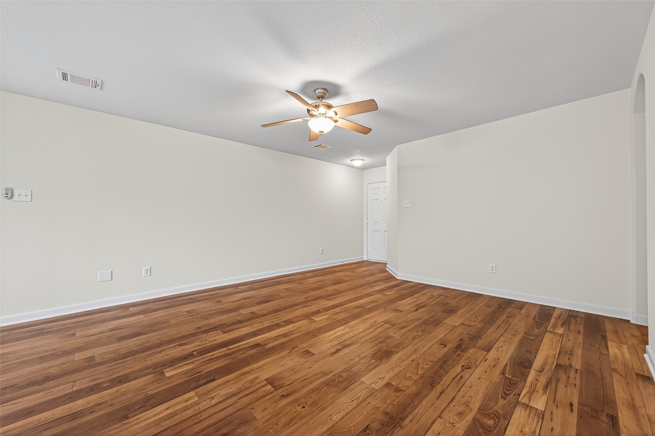 4107 Pedernales River Lane Spring, TX 77386 - Photo 11 of 33 a view of a big room with wooden floor and a ceiling fan