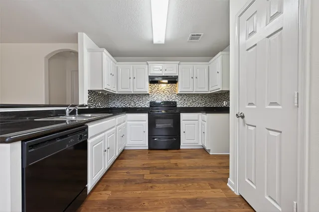 a kitchen with stainless steel appliances granite countertop a stove and a refrigerator