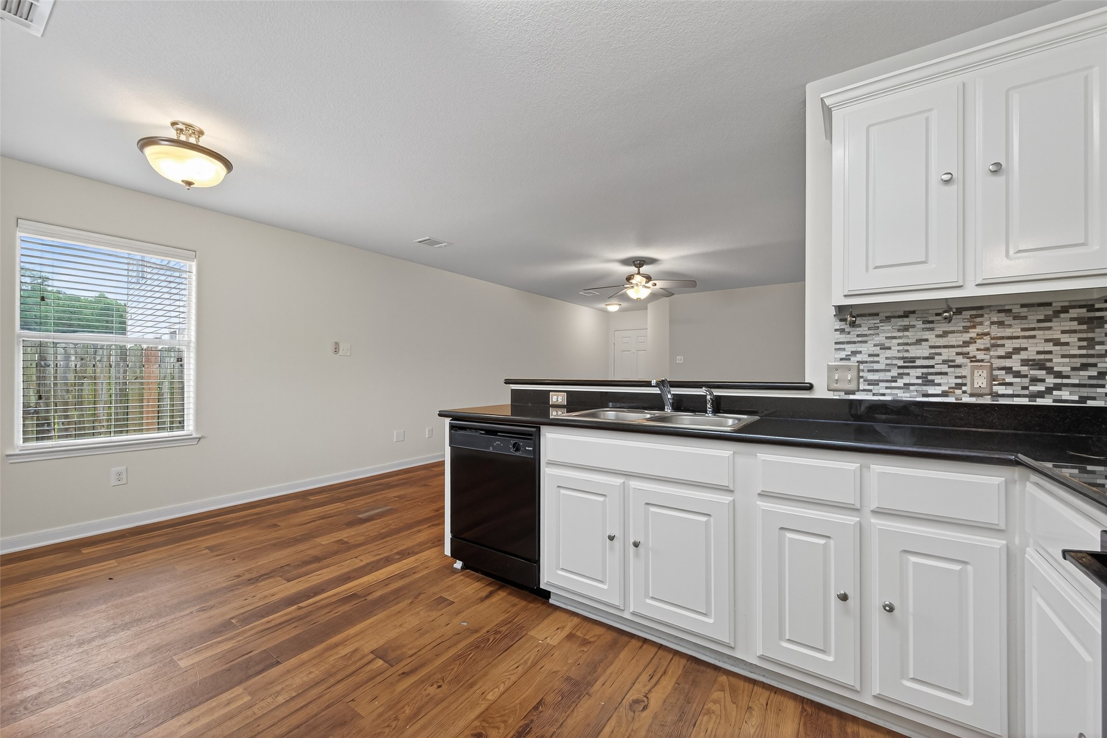 4107 Pedernales River Lane Spring, TX 77386 - Photo 17 of 33 a kitchen with granite countertop white cabinets and a sink