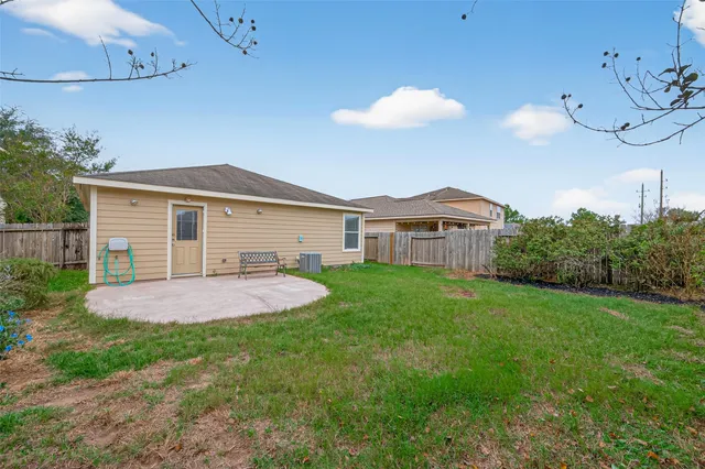 a view of a house with a backyard and plants