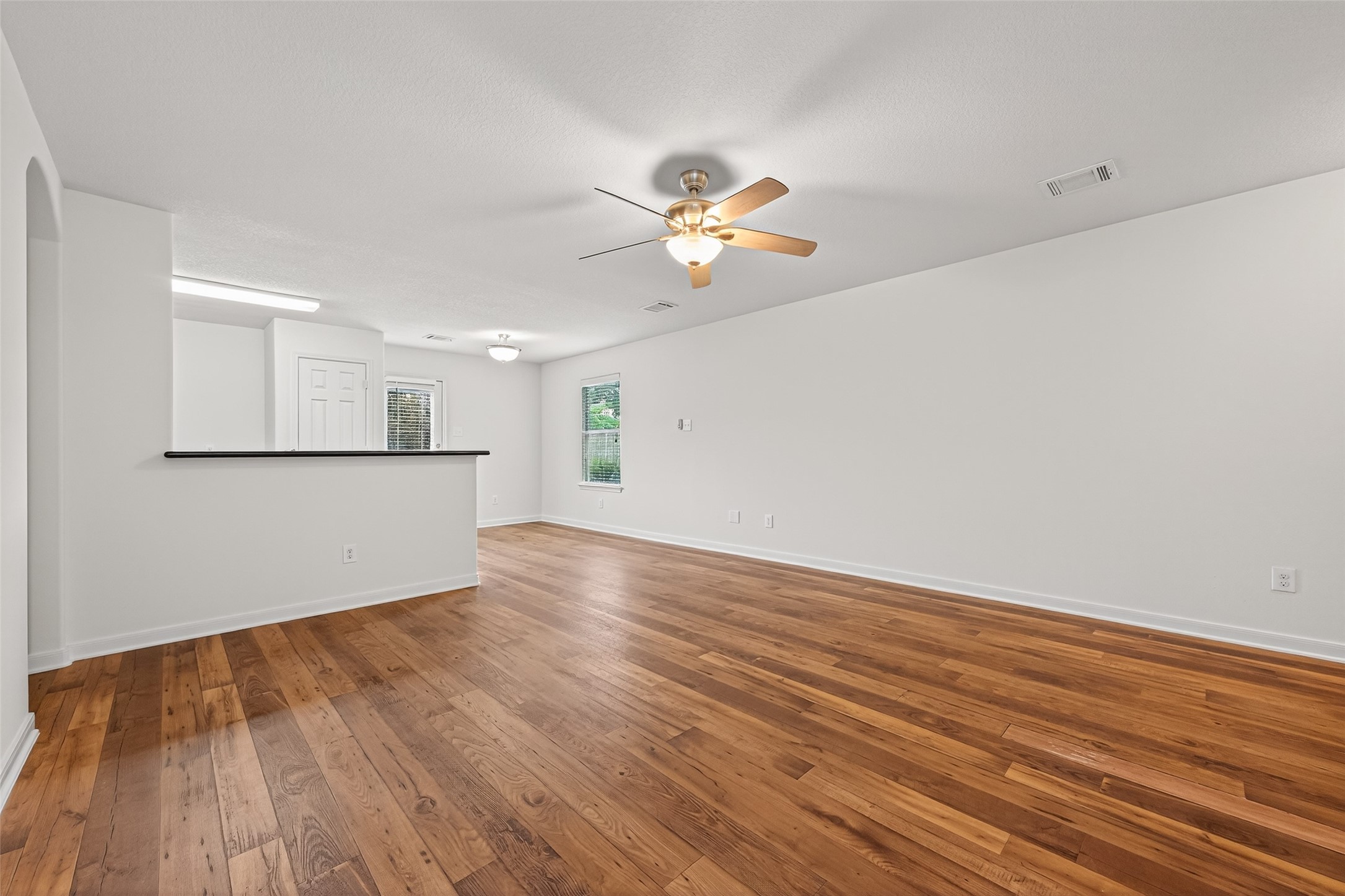 4107 Pedernales River Lane Spring, TX 77386 - Photo 10 of 33 a view of a room with wooden floor and a ceiling fan