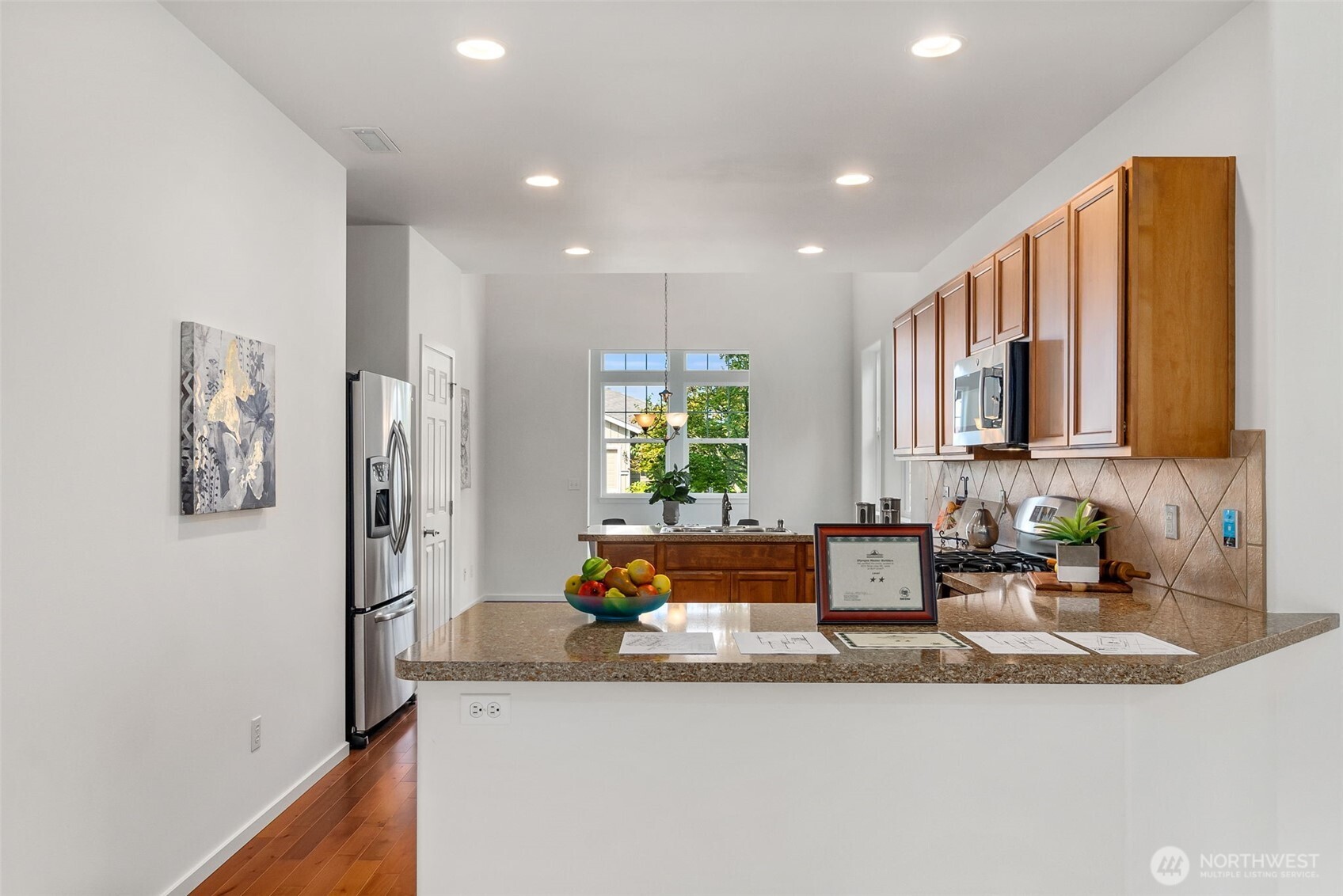 8231 Orcas Loop Northeast Lacey, WA 98516 - Photo 11 of 23 a kitchen with stainless steel appliances granite countertop a sink and a refrigerator