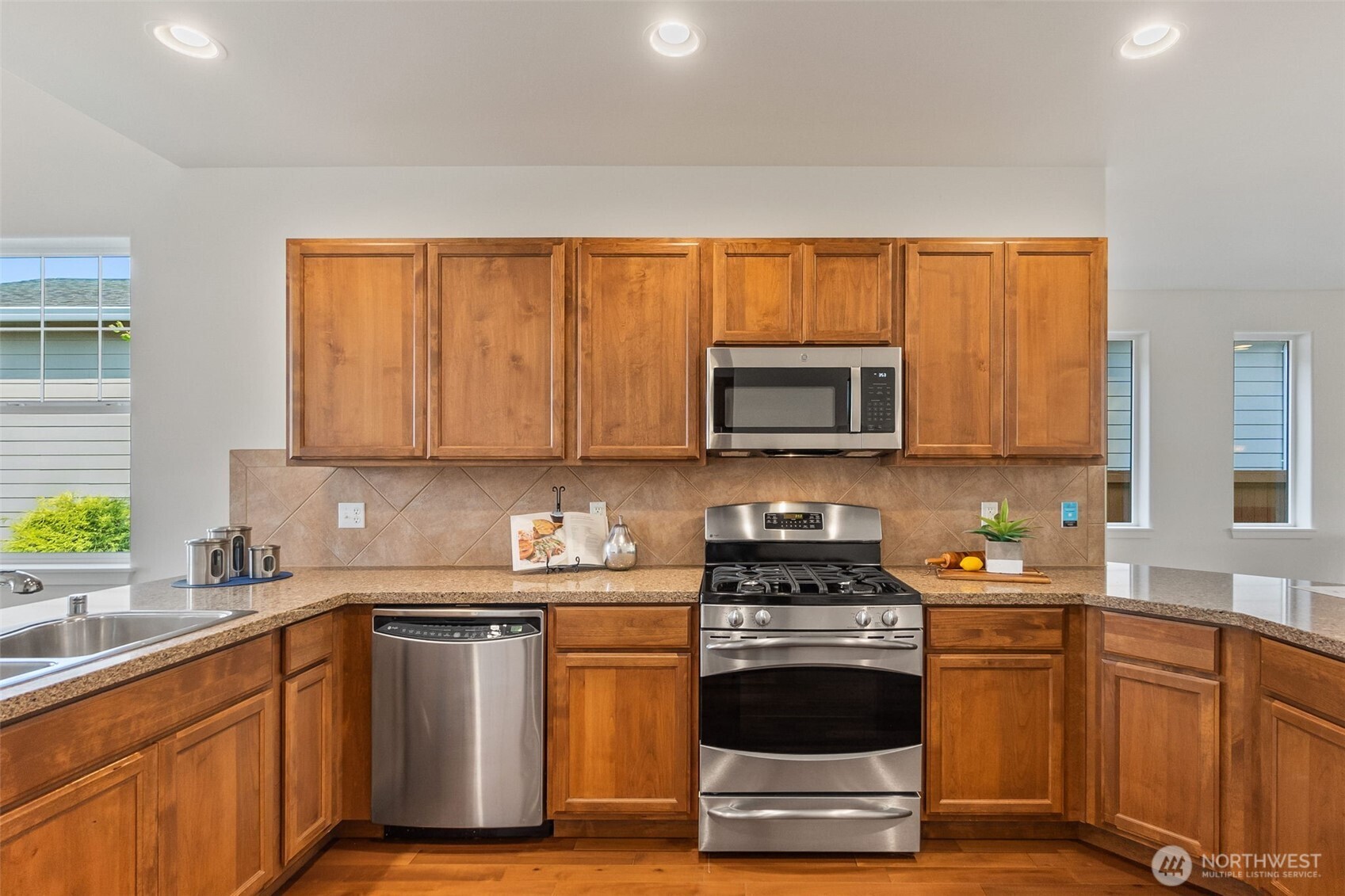 8231 Orcas Loop Northeast Lacey, WA 98516 - Photo 10 of 23 a kitchen with stainless steel appliances a stove a sink and a microwave