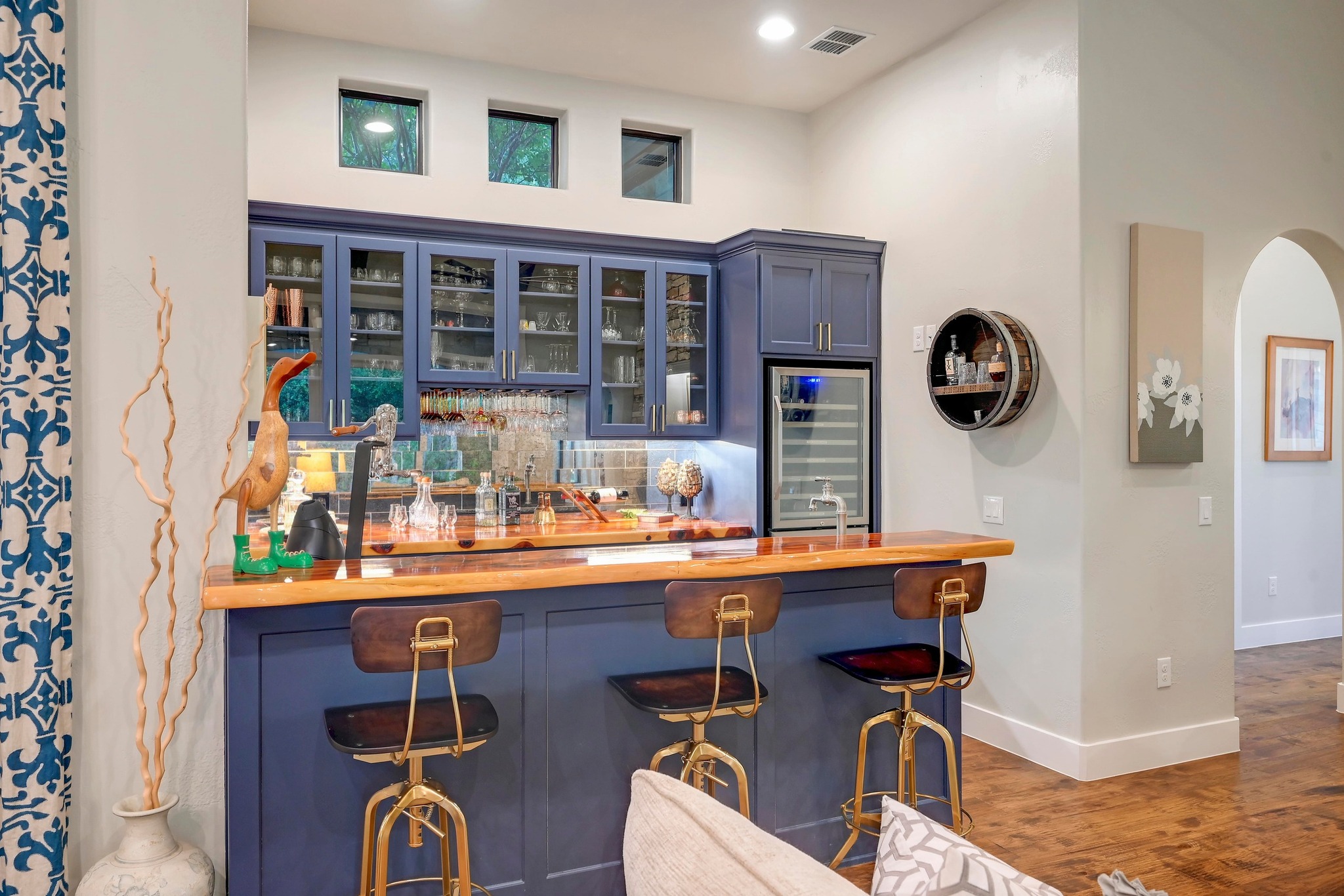 401 Trail Ridge Road Wimberley, TX 78676 - Photo 6 of 34 Indoor wet bar with blue cabinetry, glass insert cabinets, wine cooler, dark wood finished floors, and wood counters