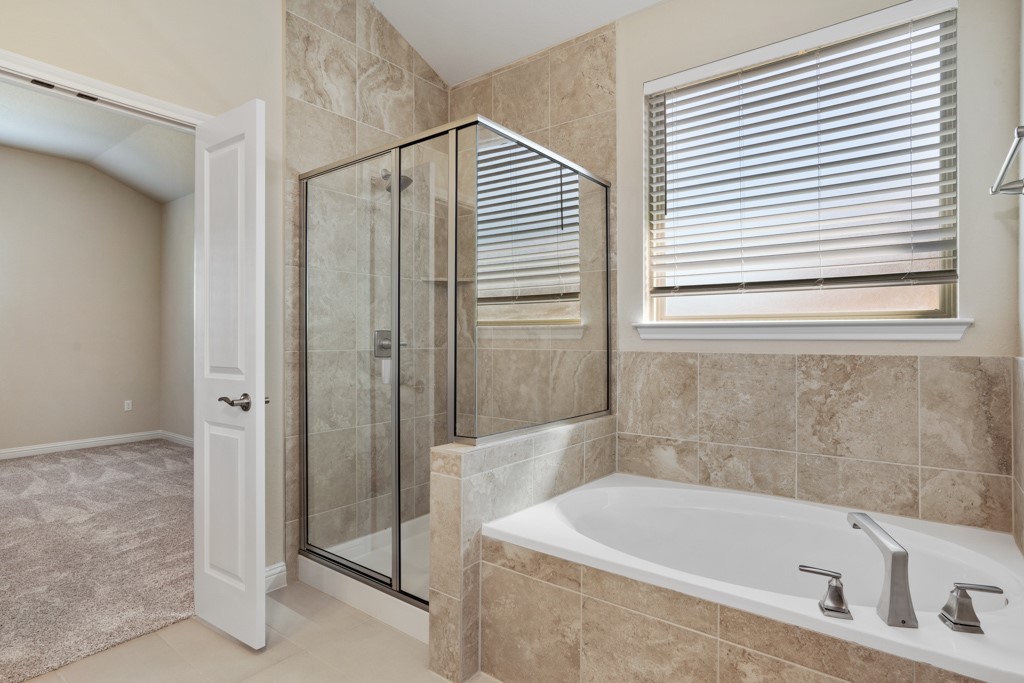 8202 Dampton Lane Austin, TX 78744 - Photo 16 of 25 a bathroom with a bathtub and a shower