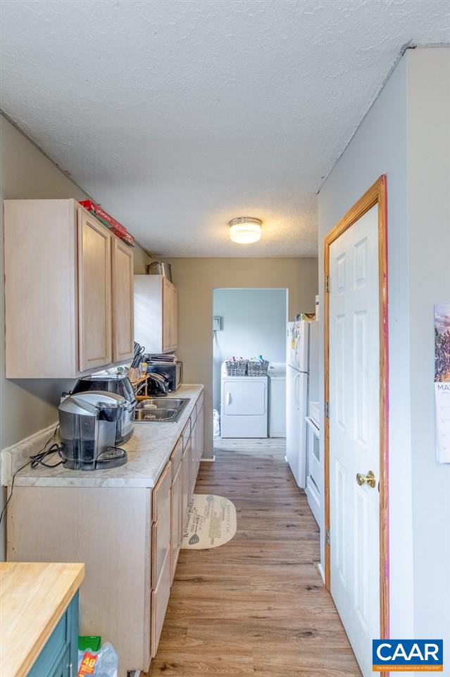 1504 Adial Road Faber, VA 22938 - Photo 14 of 22 a kitchen with a stove a refrigerator and a view of living room