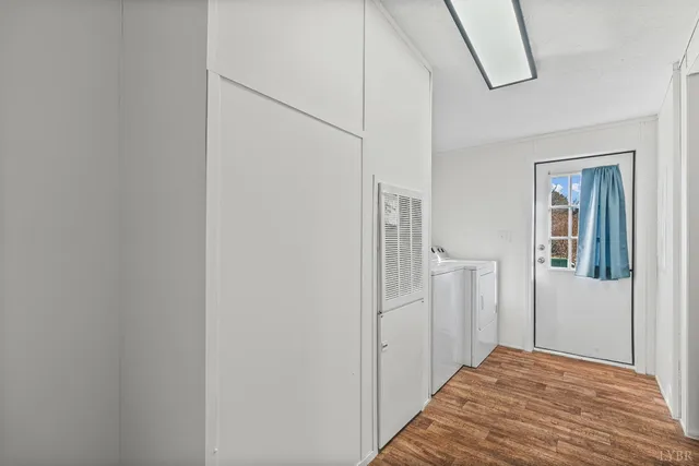 a view of a hallway with wooden floor and entryway
