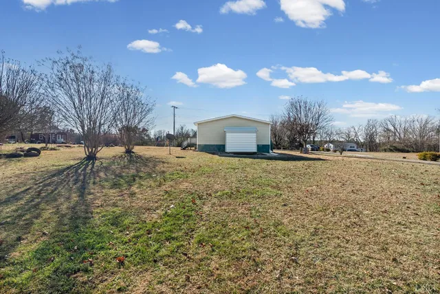 a view of open space with yard and mountain view in back