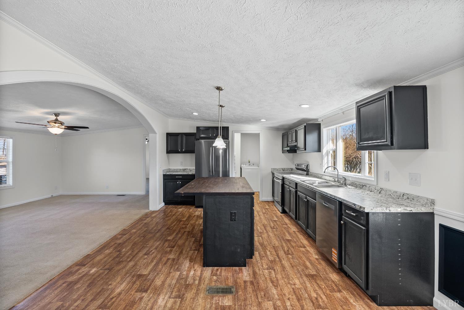 13116 Brookneal Highway Gladys, VA 24554 - Photo 6 of 34 a large kitchen with cabinets wooden floor and stainless steel appliances