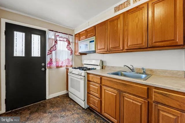 a kitchen with stainless steel appliances granite countertop a refrigerator sink and cabinets