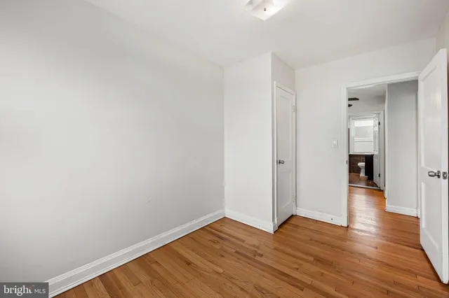 a view of an empty room and wooden floor