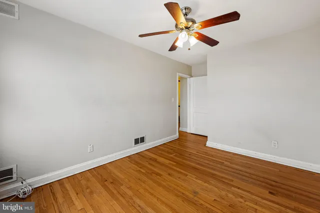 an empty room with wooden floor